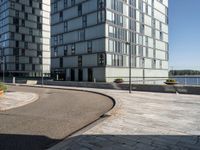 two buildings that are in front of each other and on the ground is a street with brick pavements