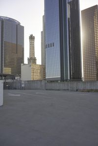 a group of skyscrapers near a bench in the city park with a skate board