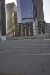 a group of skyscrapers near a bench in the city park with a skate board