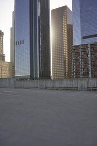 a group of skyscrapers near a bench in the city park with a skate board