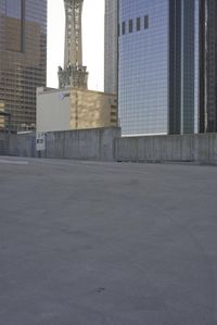 a group of skyscrapers near a bench in the city park with a skate board