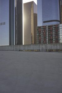 a group of skyscrapers near a bench in the city park with a skate board