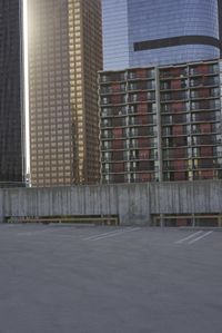 a group of skyscrapers near a bench in the city park with a skate board