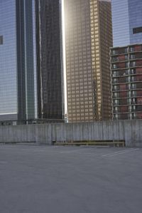 a group of skyscrapers near a bench in the city park with a skate board