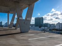 an open rooftop with a sky line and white buildings in the background in a city