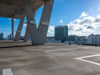 an open rooftop with a sky line and white buildings in the background in a city