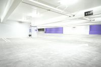 a parking garage with a purple door and several signs attached to it is very spacious