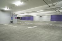 a parking garage with a purple door and several signs attached to it is very spacious