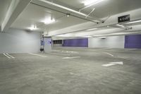 a parking garage with a purple door and several signs attached to it is very spacious