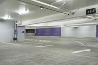 a parking garage with a purple door and several signs attached to it is very spacious