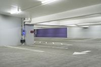 a parking garage with a purple door and several signs attached to it is very spacious