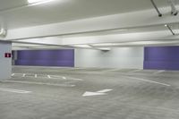 a parking garage with a purple door and several signs attached to it is very spacious