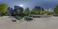 360 - degree photograph showing large building with many windows in the middle of the day