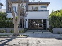 the house is located on one corner and has three stories above it and a large glass window