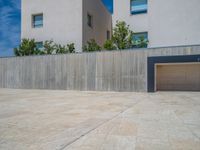 the gray concrete walls of a building have a line of steps on the left side