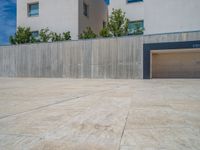 the gray concrete walls of a building have a line of steps on the left side