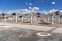 a row of solar panels on the ground of a solar park in the desert setting