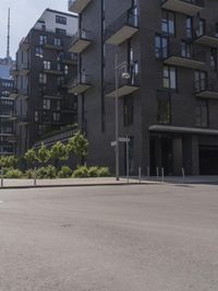 a small boy is skateboarding in an empty area of a city street near tall buildings