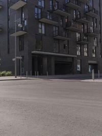 a small boy is skateboarding in an empty area of a city street near tall buildings