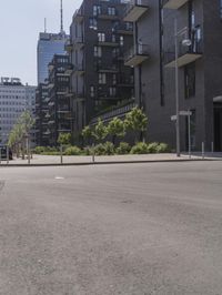 a small boy is skateboarding in an empty area of a city street near tall buildings