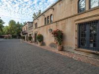 the courtyard of a small old country town house in the afternoon with the sky in the background