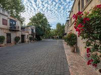 the courtyard of a small old country town house in the afternoon with the sky in the background