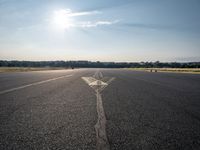 a small plane is about to take off from an airport runway on a sunny day