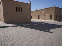 a very small street with many buildings and a person on a sidewalk in the middle of it