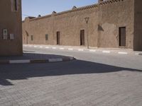 a very small street with many buildings and a person on a sidewalk in the middle of it