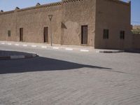 a very small street with many buildings and a person on a sidewalk in the middle of it