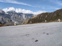 a bench is shown in front of some snow - capped mountains and a valley with rocks