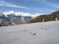 a bench is shown in front of some snow - capped mountains and a valley with rocks