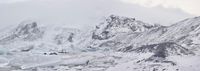 a large glacier with many melting pieces on it's surface, including small mountains