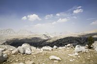 Snow-Capped Mountains and Rocky Cliffs Overlooking a Lake