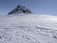 the snow covered mountain with several tracks and tracks left on it in the snow of the day