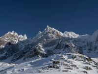 a large mountain range is shown with snow on it's ground and mountains surrounding it