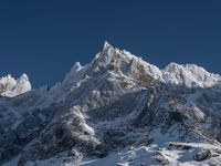 a large mountain range is shown with snow on it's ground and mountains surrounding it