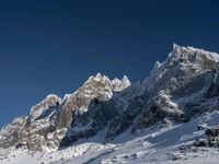 a large mountain range is shown with snow on it's ground and mountains surrounding it