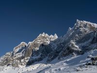 a large mountain range is shown with snow on it's ground and mountains surrounding it