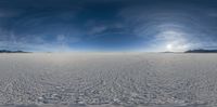 a panorama of snow covering an arid plain in the desert with two jets flying above