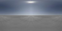 an empty beach covered in snow and blue sky over the sand plain with a sunbeam