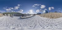 the view of the snow and city from outside the gate of the tunnel, as seen from this fish eye lens