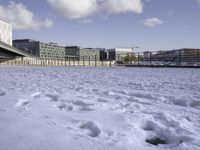 there is snow on the ground outside the buildings of an area with white snow and a blue sky