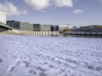 there is snow on the ground outside the buildings of an area with white snow and a blue sky