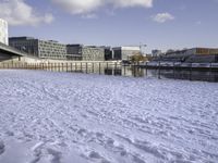 there is snow on the ground outside the buildings of an area with white snow and a blue sky