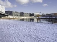 there is snow on the ground outside the buildings of an area with white snow and a blue sky