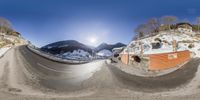 a panorama lens that is on the side of a snow covered hill at a ski resort