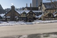 an old building that has been snowed out on a snowy day, on the side of a street