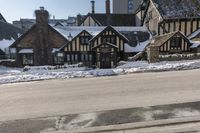 an old building that has been snowed out on a snowy day, on the side of a street