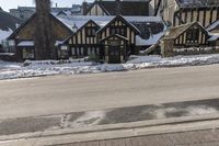 an old building that has been snowed out on a snowy day, on the side of a street